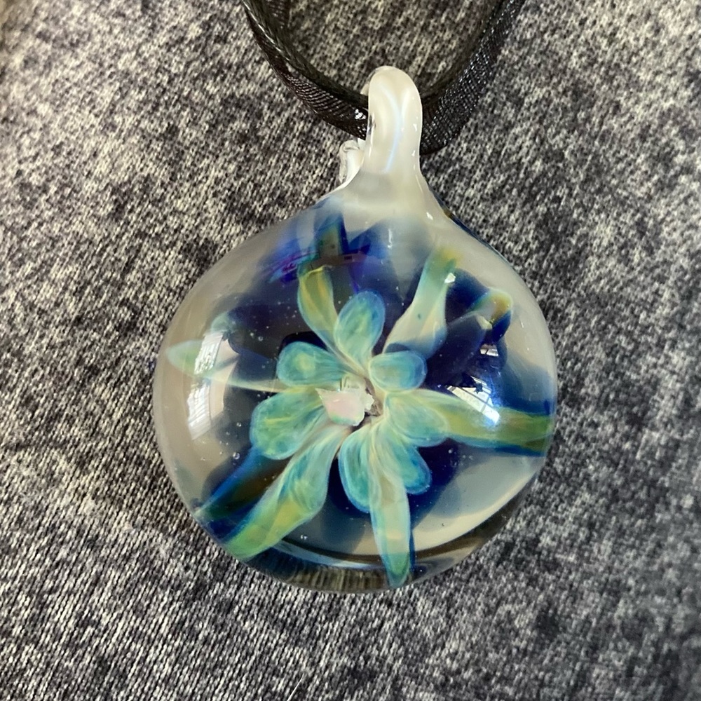 Flower implosion glass pendant with a lab created opal at the center